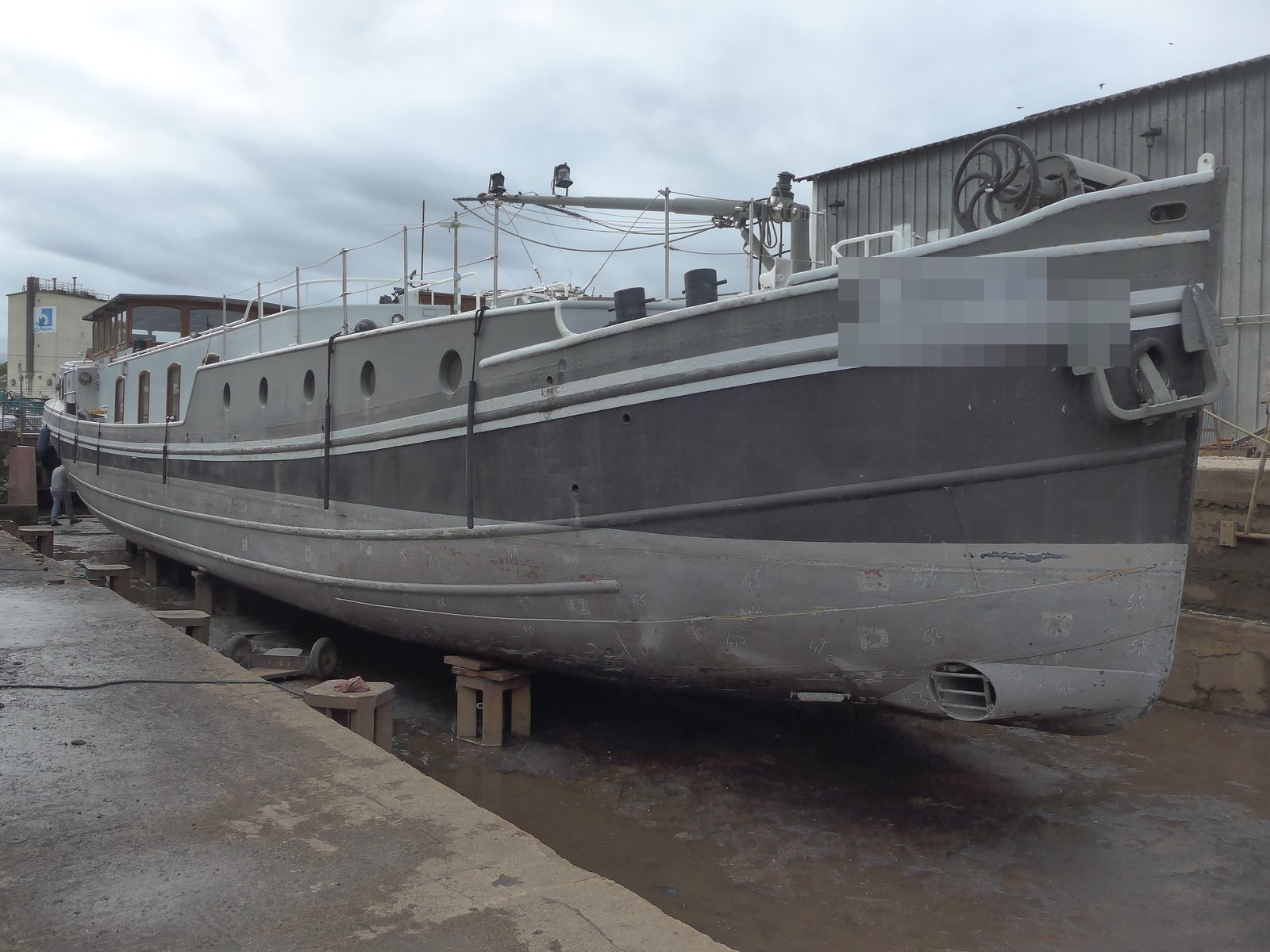 Barge in dry dock for hull survey